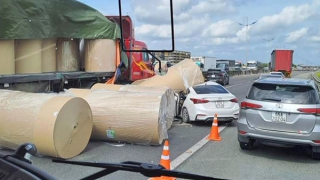 Cuộn giấy rơi từ thùng xe đầu kéo đè nát đầu xe con