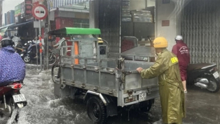 CSGT đội mưa giúp người dân di chuyển qua vùng nước ngập sâu