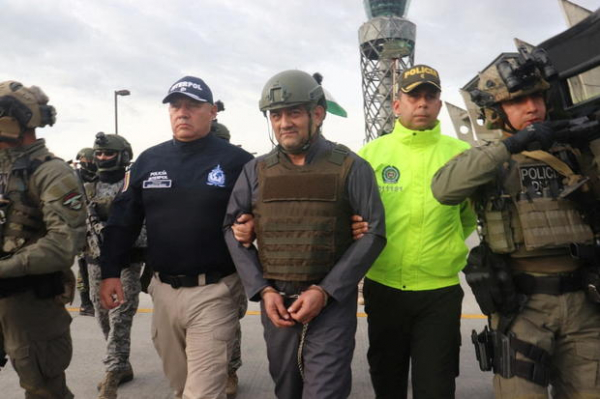 r- colombian drug trafficker dairo antonio usuga david, also known as _otoniel_, gets escorted by police officers after colombia extradites him to the united states, in bogota, colombia may 4, 2022. .jpg -0