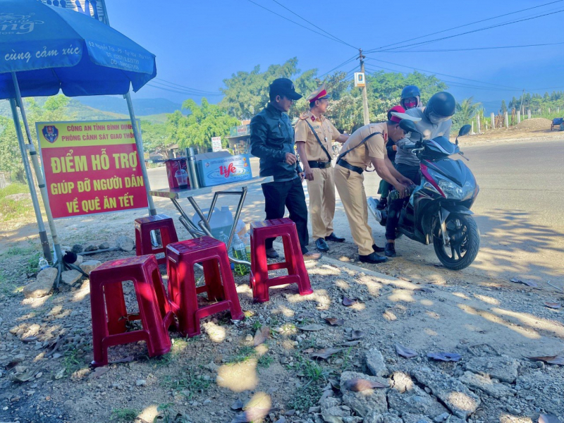 CSGT tặng mũ bảo hiểm, bánh chưng để tiếp sức cho người dân về quê ăn Tết -0