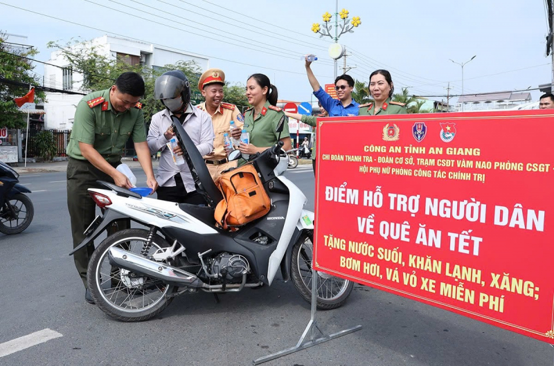 CBCS Công an tỉnh An Giang phát nước suối, xăng tặng người dân về quê đón Tết -0